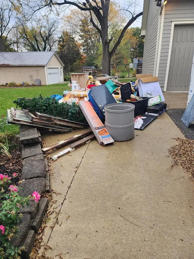 Dumpster being loaded with debris for Roofing Dumpster Rental in Highwood